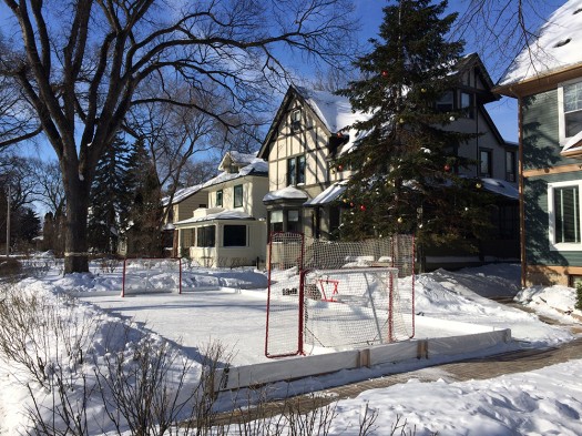 Two houses pooled their front yards to build an informal hockey rink - ubiquitous with Winnipeg winter.